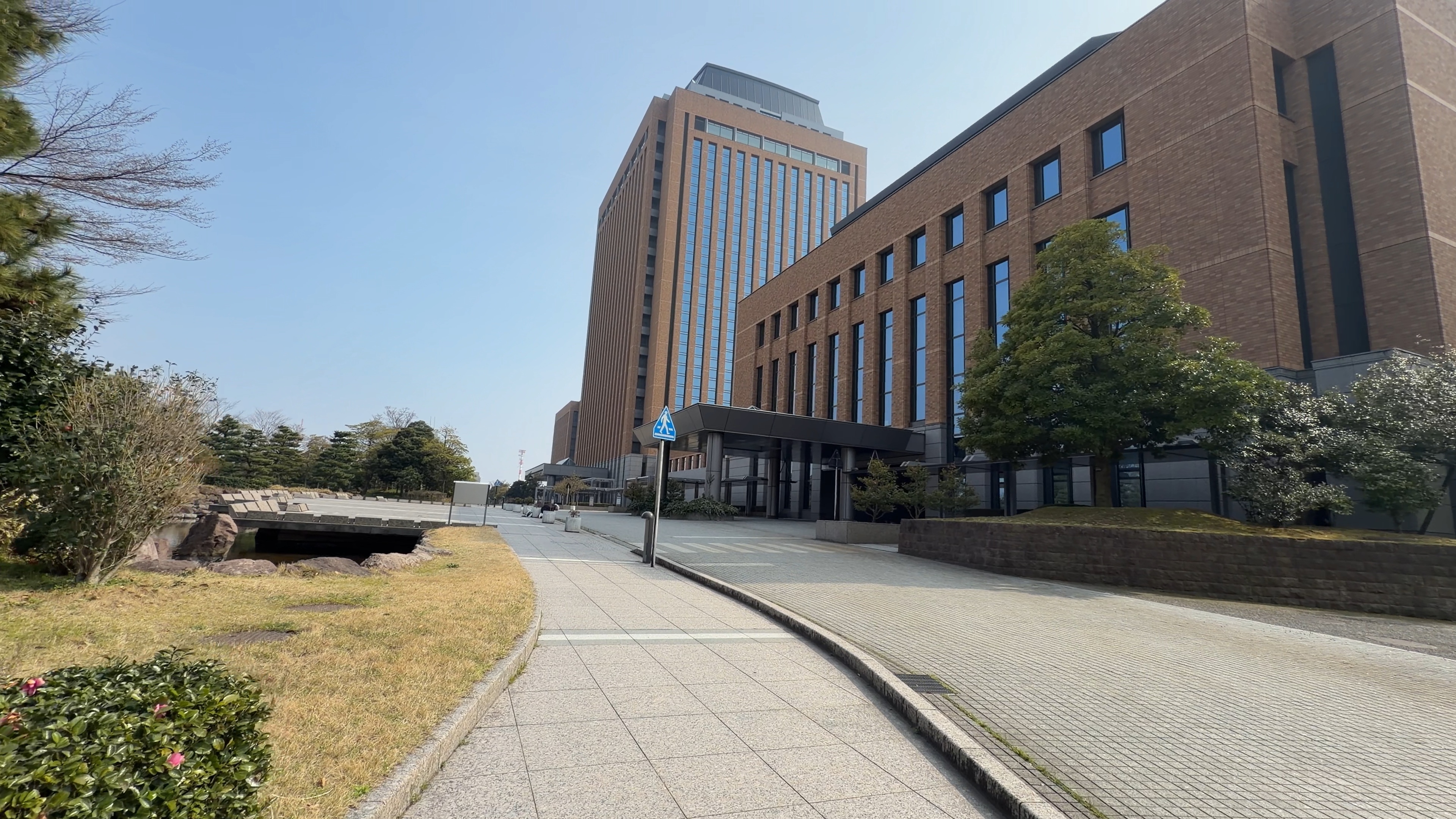 横断歩道と案内標識越しに見える議会庁舎・行政庁舎