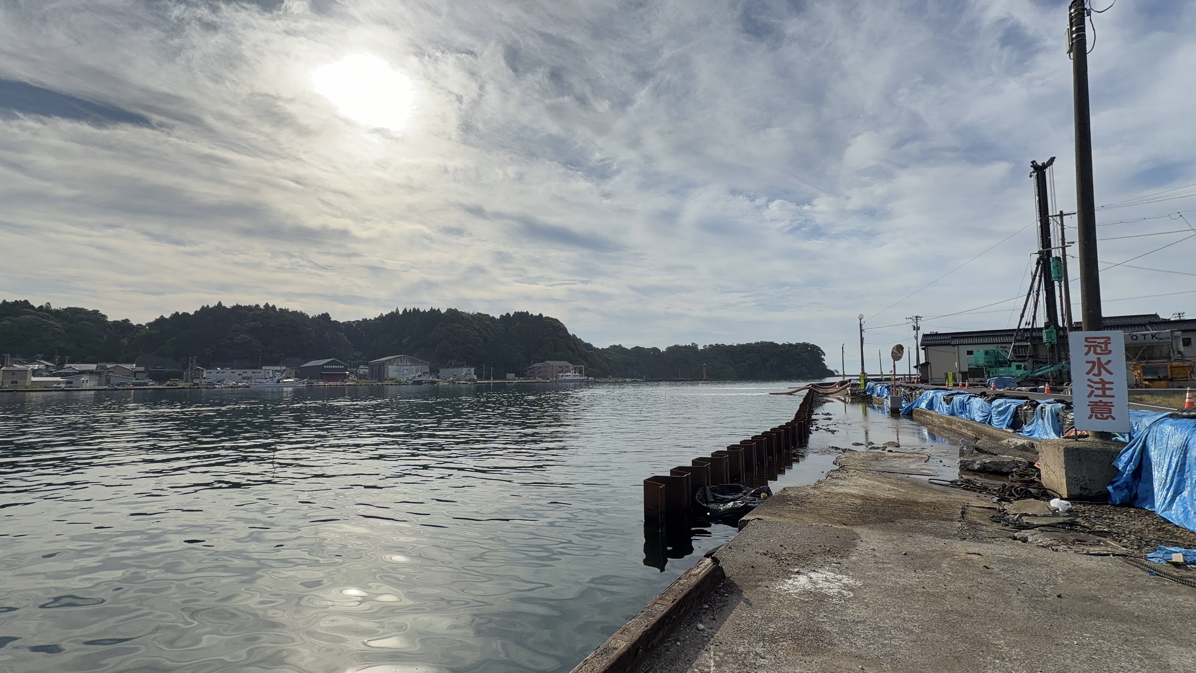 冠水注意の看板と港の水面