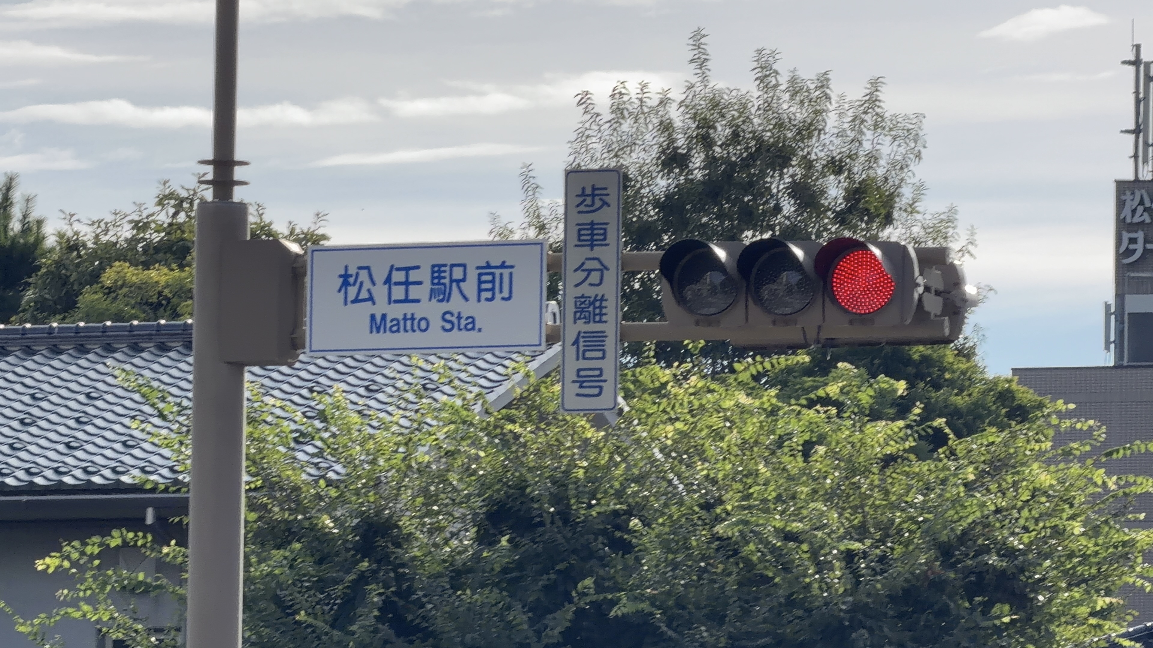 「松任駅前 Matto Sta.」の交差点標識と歩車分離信号、赤信号