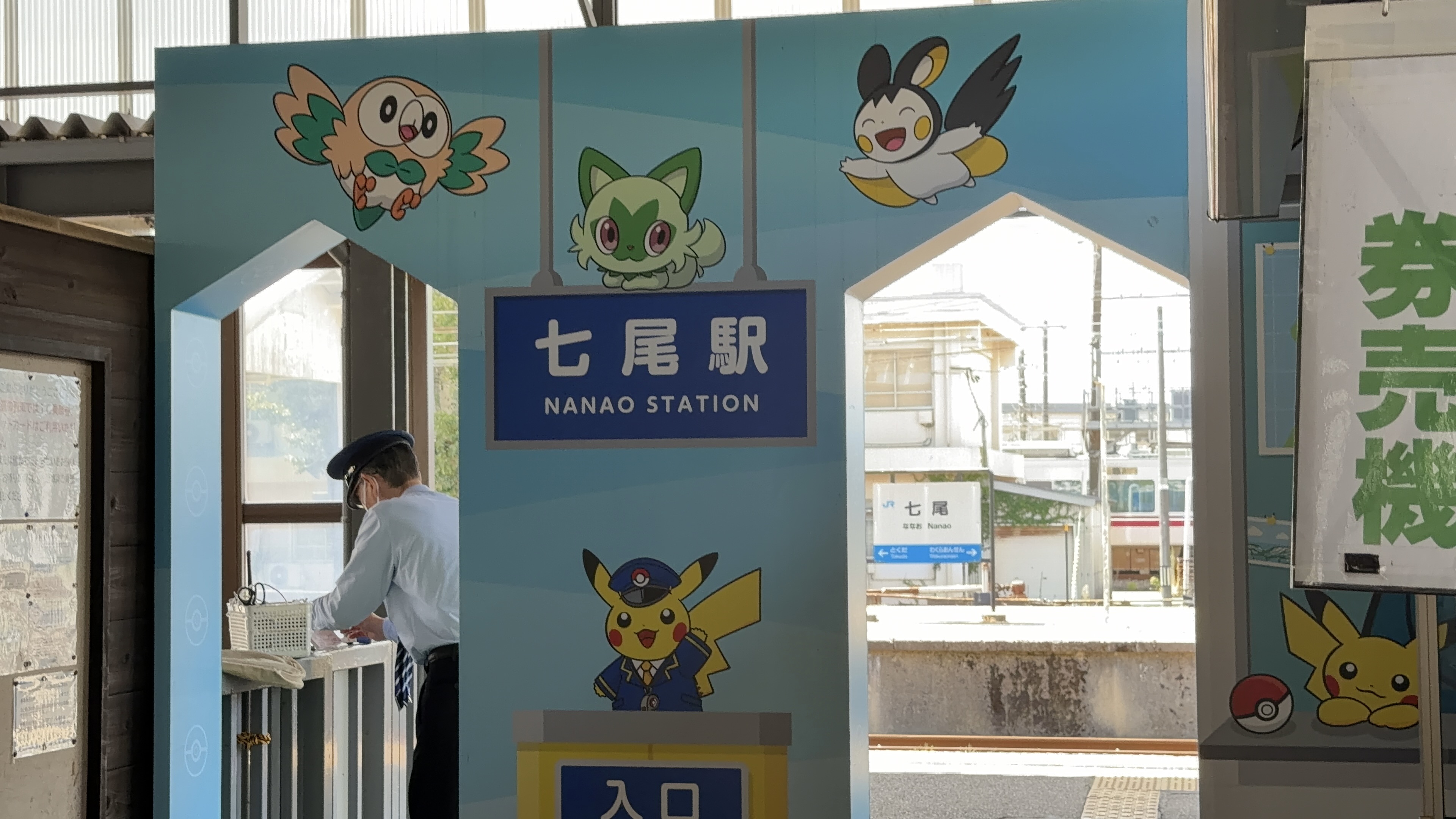 七尾駅の改札まわり、ポケモンのイラストが飾られたアーチと「七尾駅 NANAO STATION」の駅名標、奥にホーム